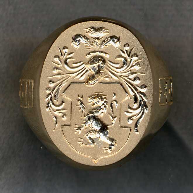 Ring after we removed a broken stone and substituted a plate of 14k gold where we have engraved a family crest
