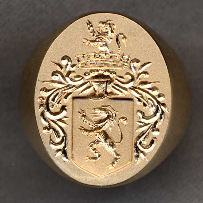 A 14k gold signet ring engraved with a Family Crest or Coat of Arms.