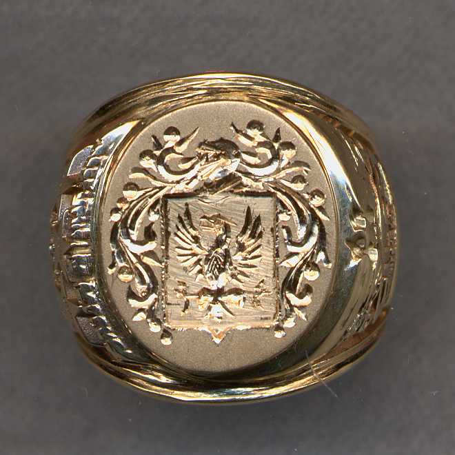 Graduation ring with stone removed as well as the top level of gold. We then added a plate and engraved a family crest.