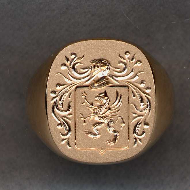 This was an old solid gold ring with initials etched on the surface. We have removed initials and engraved the family crest on the resulting surface.